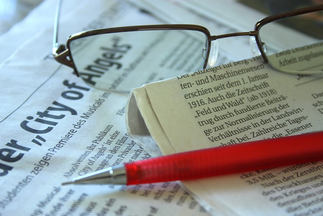 A person reading a news story to identify facts and opinions