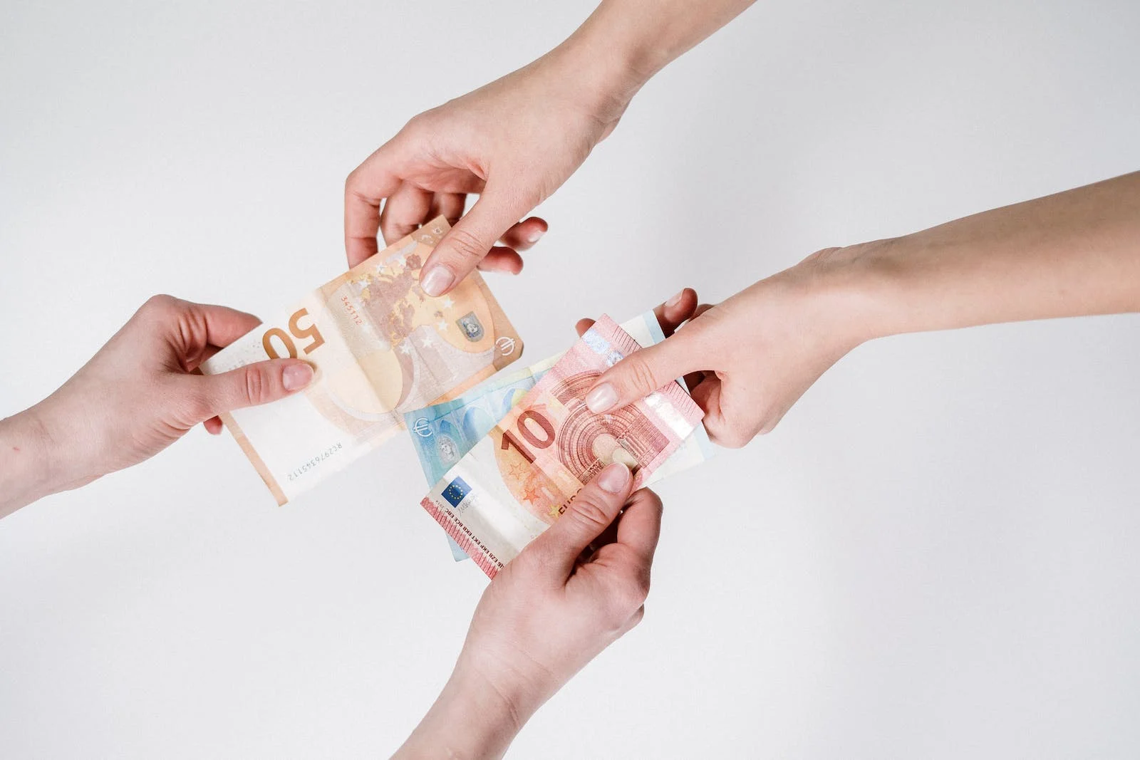 An illustration showing the process of money laundering and racketeering with multiple hands exchanging cash and documents.