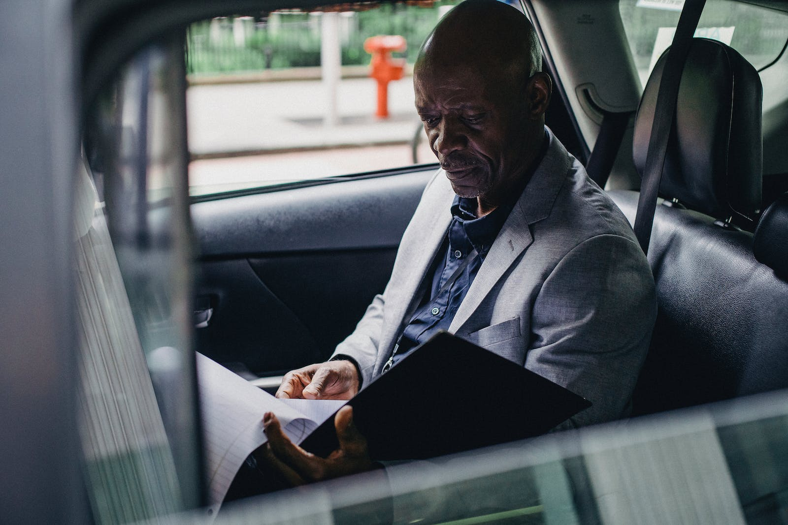 A man in a suit pointing at a document, representing infamous racketeering cases