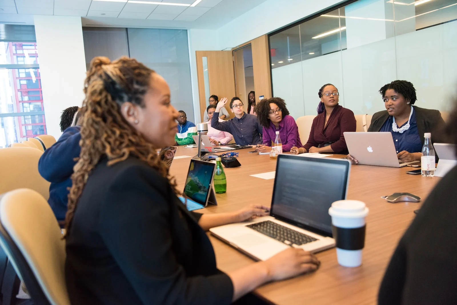 An image showing a group of employees attending a training session on crypto money laundering awareness program.