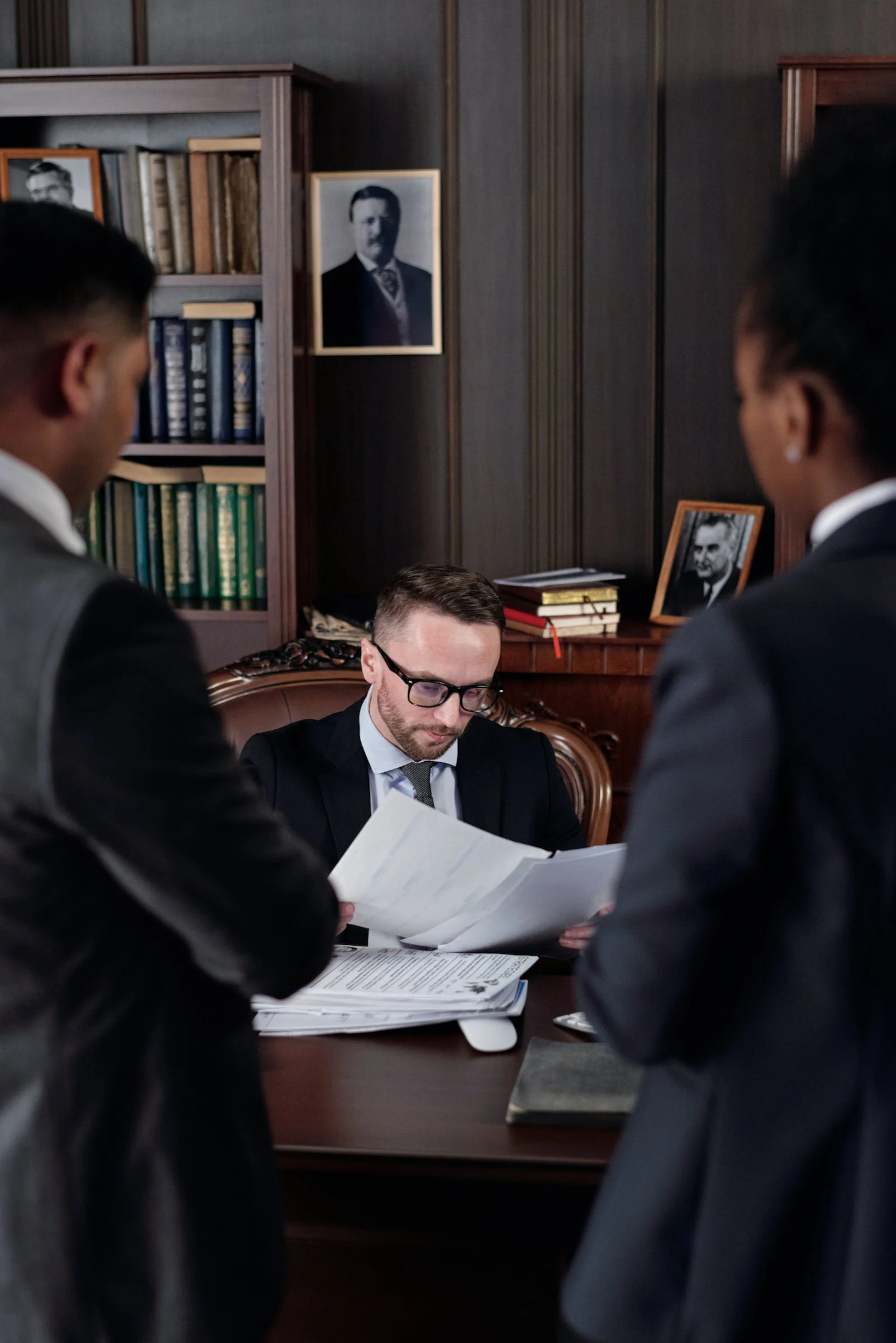 A man in a suit pointing at a document, representing the relationship between money laundering and crimes